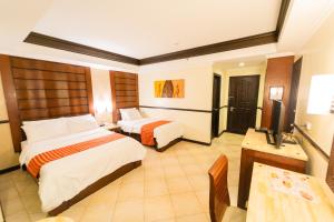 Postel nebo postele na pokoji v ubytování MO2 Westown Hotel Iloilo + 18 fotografií