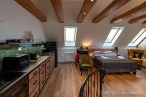 a bedroom with a bed and a kitchen in a room at Eger Castle Hill Premium Apartments in Eger