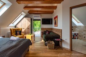 a attic bedroom with a bed and a bathroom at Eger Castle Hill Premium Apartments in Eger