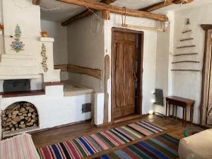a living room with a fireplace and a wooden door at Екосадиба Лісова Казка in Dmitrenki