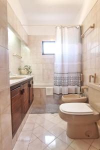 a bathroom with a toilet and a sink at Rustic Beach House at the Cliff T3 | C218 in Porches