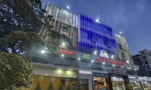 a building with blue lights on top of it at Treebo Savoury Sea Shell Residency in Bengaluru