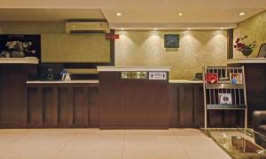 a bar in a restaurant with a counter at Treebo Savoury Sea Shell Residency in Bengaluru