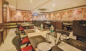 a restaurant with tables and chairs in a room at Treebo Trend Savoury Sea Shell Residency in Bangalore