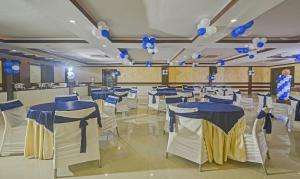 a banquet hall with blue and white tables and balloons at Treebo Savoury Sea Shell Residency in Bengaluru