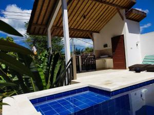 a swimming pool in front of a house at Penida Dream Homestay and hostel in Nusa Penida
