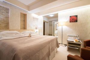 Säng eller sängar i ett rum på Ioana Hotel