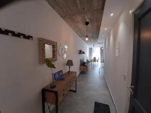 a hallway with white walls and a wooden ceiling at QLiving Central New Apartments Gzira Sliema Promenade in Il-Gżira