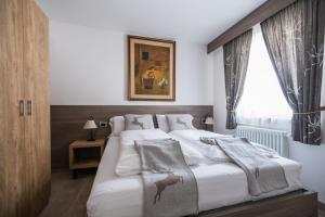Un pat sau paturi într-o cameră la Piccola Cesa Apartments