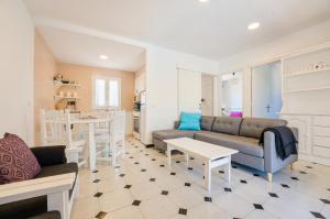 a living room with a couch and a table at Villas Vanessa & Ruth in Cala'n Porter