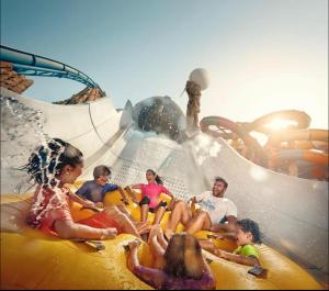 a group of people sitting on a ride on a water slide at Yas Island in Abu Dhabi