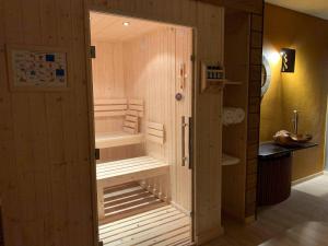a sauna with a bench in the middle of a room at hotel des Sapins in Lanarce