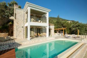 a villa with a swimming pool and a house at Villa Anthelia-Idyllic view and private access to the sea in Sivota
