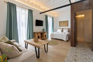 a living room with a bed and a couch at Tu casa en Herrera el viejo in Seville