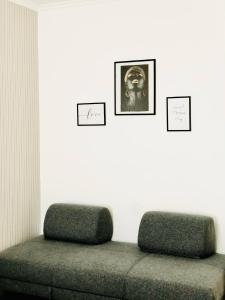 a room with a couch and two pictures on the wall at B&B Da Jana in Pordenone