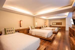 Postel nebo postele na pokoji v ubytování Pandawa All Suites Hotel
