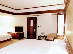Ένα ή περισσότερα κρεβάτια σε δωμάτιο στο King's Town Hotel