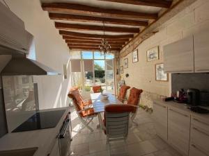a kitchen with a table and chairs in a kitchen at Maison des Arts Francueil in Francueil