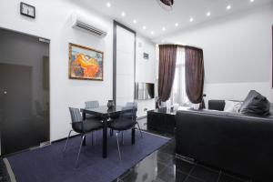 a living room with a couch and a table at Panoramic 1-BR apartment in the heart of Odessa in Odesa