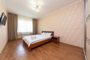 a bedroom with a bed and a television in it at Елизаветы Чавдар 34 in Kyiv +1 photo