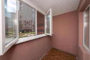 an empty room with two windows in a building at Елизаветы Чавдар 34 in Kyiv