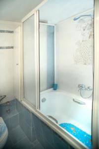 a bathroom with a bath tub with a shower at Comfort Studio in Thessaloniki
