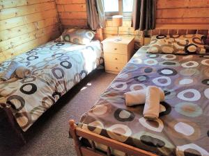 a bedroom with two twin beds with towels on them at The Cosy Mountain Cabin with Stunning Views near Troodos in Kato Amiandos