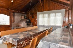 a kitchen with a table and chairs and an oven at Casa Maria in Mănăstirea Humorului