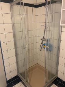 a shower with a glass door in a bathroom at Haus Wutzl in Mariazell