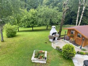 a backyard with a house and a statue of a dog at Haus Wutzl in Mariazell