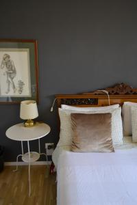 a bedroom with a bed and a table with a lamp at Osimo B&B in Osimo