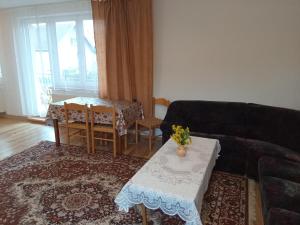 a living room with a couch and a table at Apartmány Tonka 309 in Zuberec