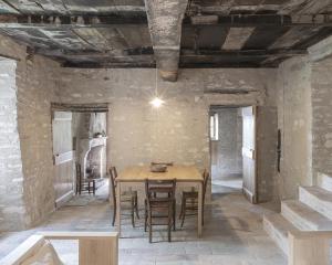 a dining room with a wooden table and chairs at Rocca Castrignano in Riano