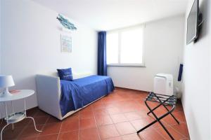 a bedroom with a bed and a table and a window at Casa Assuntina in Positano