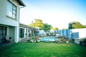 a yard with a swimming pool and a house at Langebaan-On-Sea in Langebaan