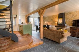 a living room with a couch and a dining room at Van Gogh Huis Medemblik in Medemblik