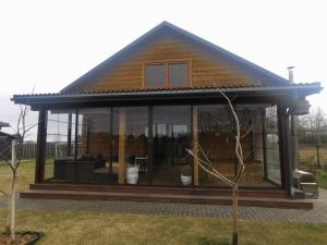 a house with large glass windows on it at Arturas Guest House in Vilnius