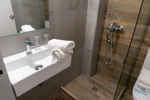 a bathroom with a sink and a shower at Roxani Hotel in Amoudara Herakliou