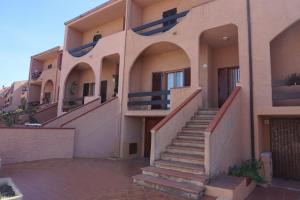 a building with stairs on the side of it at Casa Adriana in Alghero