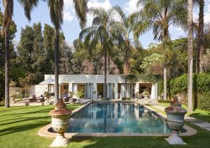 an exterior view of a house with a swimming pool at Hoeveld House in Johannesburg