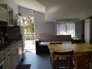 a kitchen with a table and a living room at Olékaté in Les Sables-d'Olonne