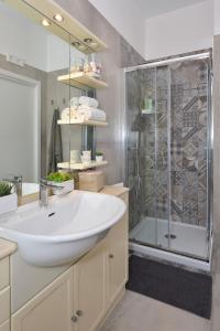 a bathroom with a white sink and a shower at Casamari Apartments in Maiori