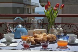 a table with a tray of pastries and orange juice at Casamari Apartments in Maiori