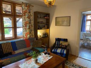 a living room with a couch and a table at Chatka mojego dziadka in Długie