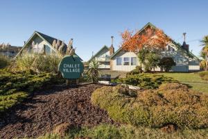 a house with a street village sign in front of it at Tidal House #10 - Ocean Shores Chalet in Ocean Shores