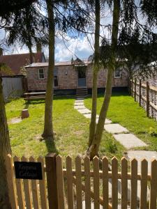 a wooden fence in front of a house at Keepers Cottage in Ipswich