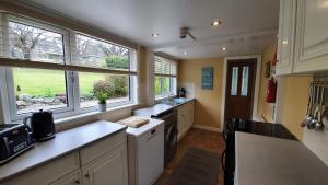 a kitchen with a sink and a dishwasher at Willows Cottage in Pitlochry