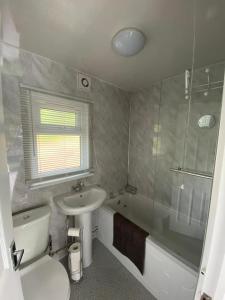 a bathroom with a sink and a toilet and a shower at 92 Lake View in Caernarfon