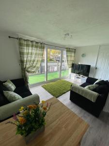 a living room with a couch and a table at 92 Lake View in Caernarfon