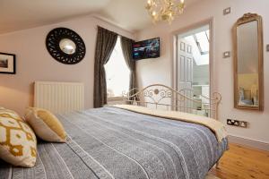 a bedroom with a bed and a mirror at Chapel Cottage Set in a private courtyard in central location with 2 parking spaces in Kirkby Lonsdale